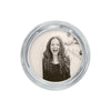 Round silver photo frame measuring 5" diameter with a raised rim holds a photo of a smiling young woman.