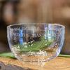 Clear glass 8.5 inch diameter bowl with engraved sentiment around the rim:  "A friend may well be reckoned the masterpiece of nature." 