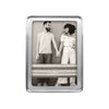 Silver photo frame 5x7 with a raised rim holds a photo of a couple holding hands..