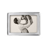 Silver photo frame 4x6  with a raised rim holds a photo of a woman kissing her bulldog.