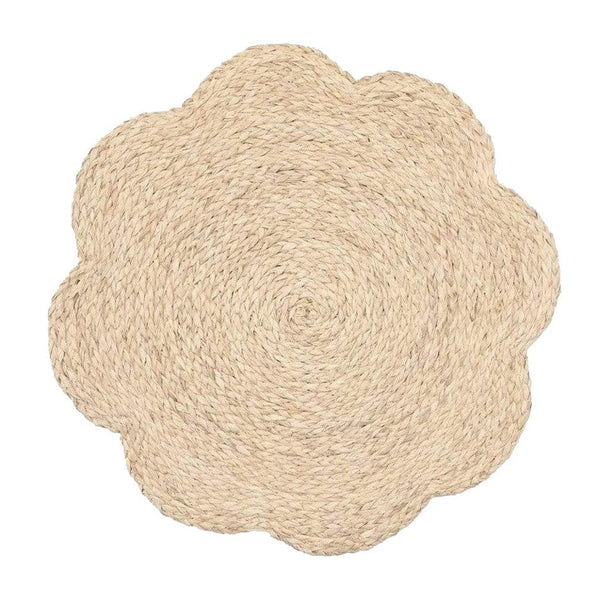 Scalloped, flower-shaped woven raffia placemat in light natural color.