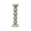 One tall taupe colored bobbin shaped candlestick.