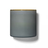 Lafco's Sea & Dune candle is housed in a hand-blown blue glass vessel with a honey-colored rim. 