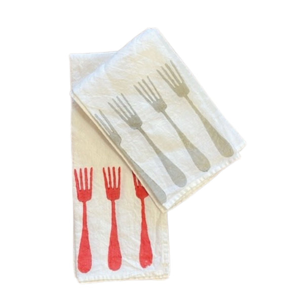 Two natural linen tea towels, one with red forks decorating the bottom edge, and one with taupe forks.