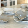 Stone and white colored melamine platters on a marble counter.