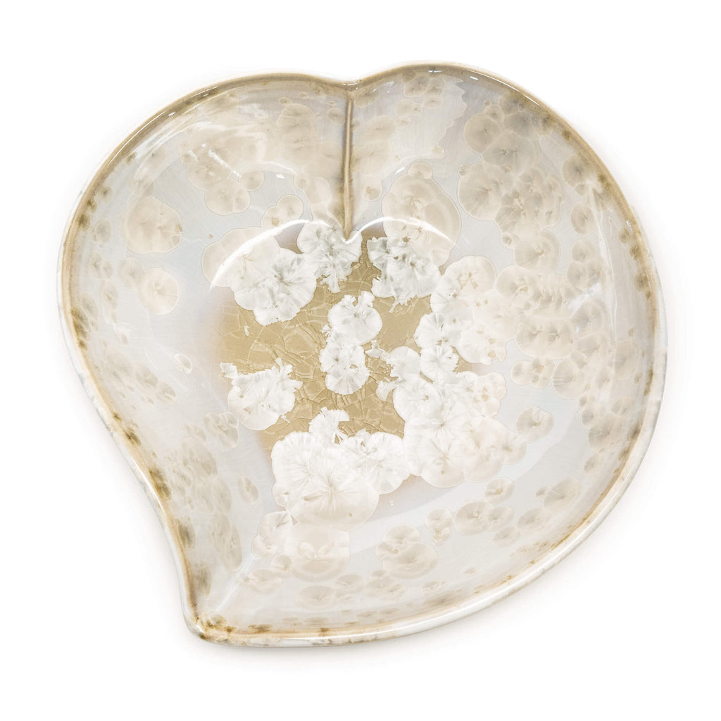 Cream and white glazed white heart bowl on white background. 