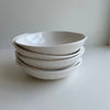 Stacked berry bowls on a white background.