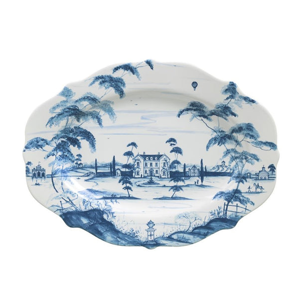 Juliska's Country Estate Delft Blue 18" platter is decorated with an illustration of a country manor house.