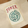Canvas mahjong tile pouch with joker tile design on a wooden surface