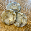 Four agate coasters on a wooden surface.