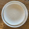 Double lined melamine salad and dinner plate on wood surface.