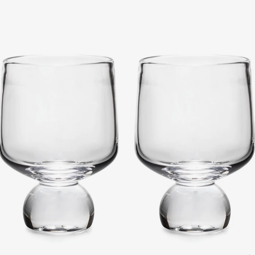 Two bourbon glasses on white background.