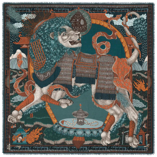 This silk and wool scarf designed by Sabina Savage depicts a  snow lion of Tibet wearing traditional armor. The scarf 's design is colored in rich teal and oranges.
