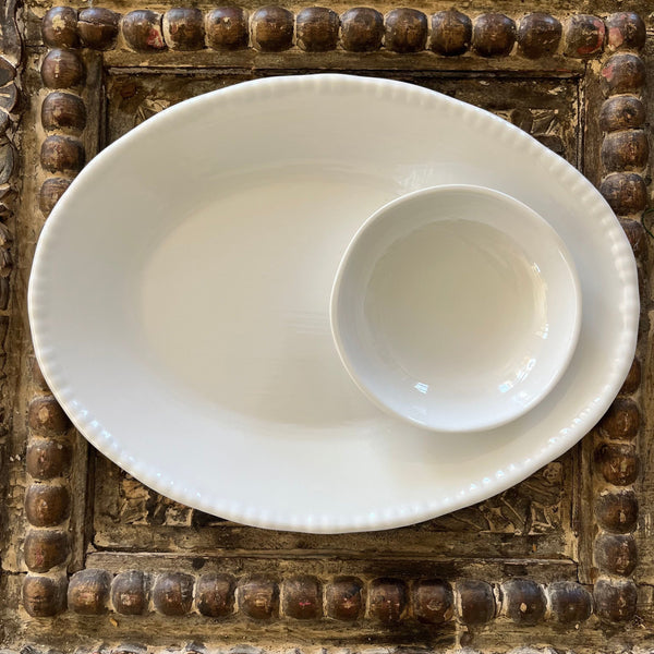 White beaded platter and small bowl on wooden decorative board. 