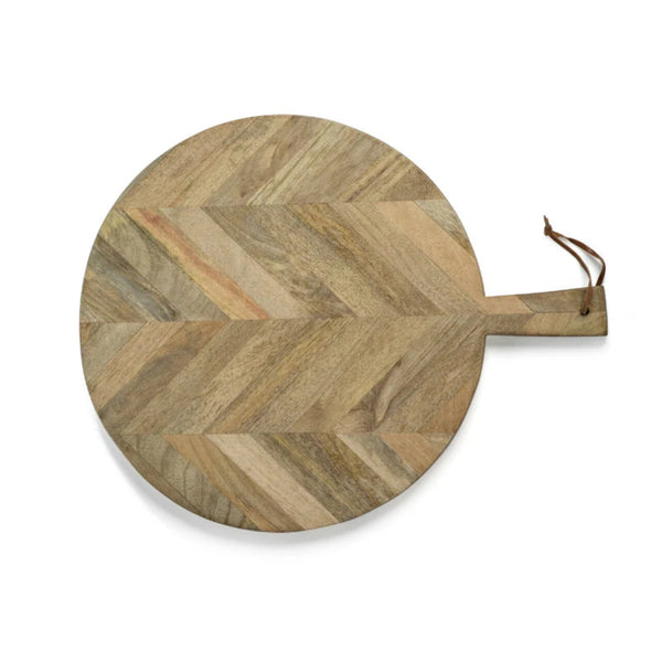 Large round wooden cheese board with chevron pattern on white background. 