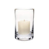 Clear glass cylindrical hurricane candle holder with cream candle on white background.