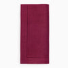 Berry colored linen napking on white background.