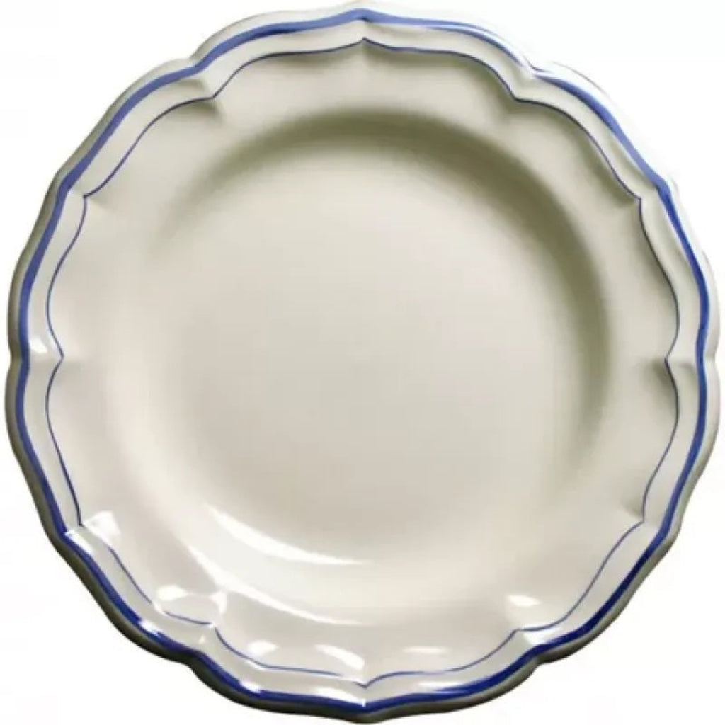 Ceramic platter with scalloped edge and blue rim on a white background