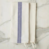 Folded blue and white towel on a marble surface