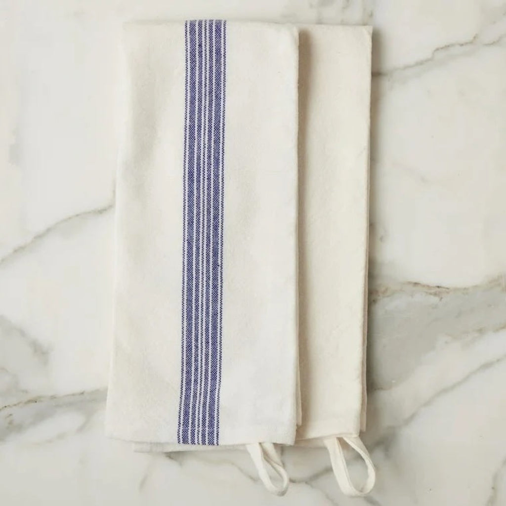 Folded blue and white towel on a marble surface
