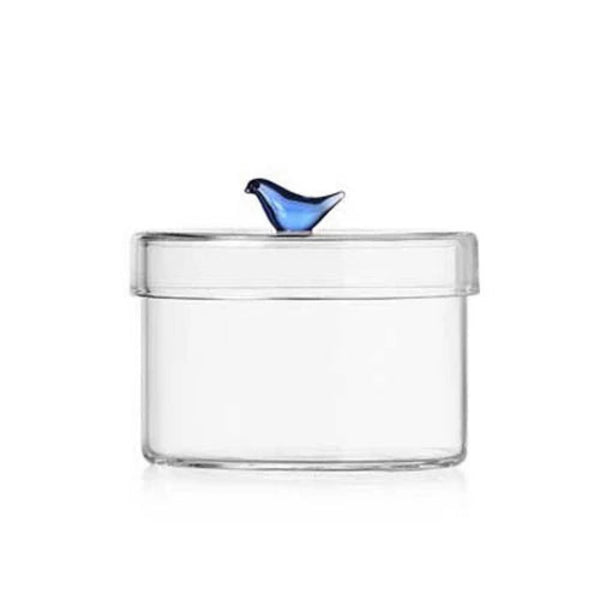 Cyclindrical clear box with bluebird on top. 