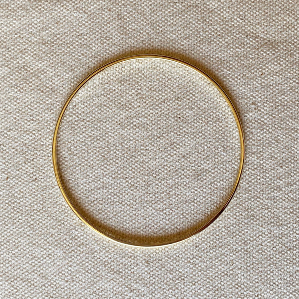 Gold filled bracelet on linen background.