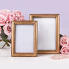 Two Chatelet gold photo frames stand vertically against a background of pink roses. One measures 4"x6" and one measures 5"x7."