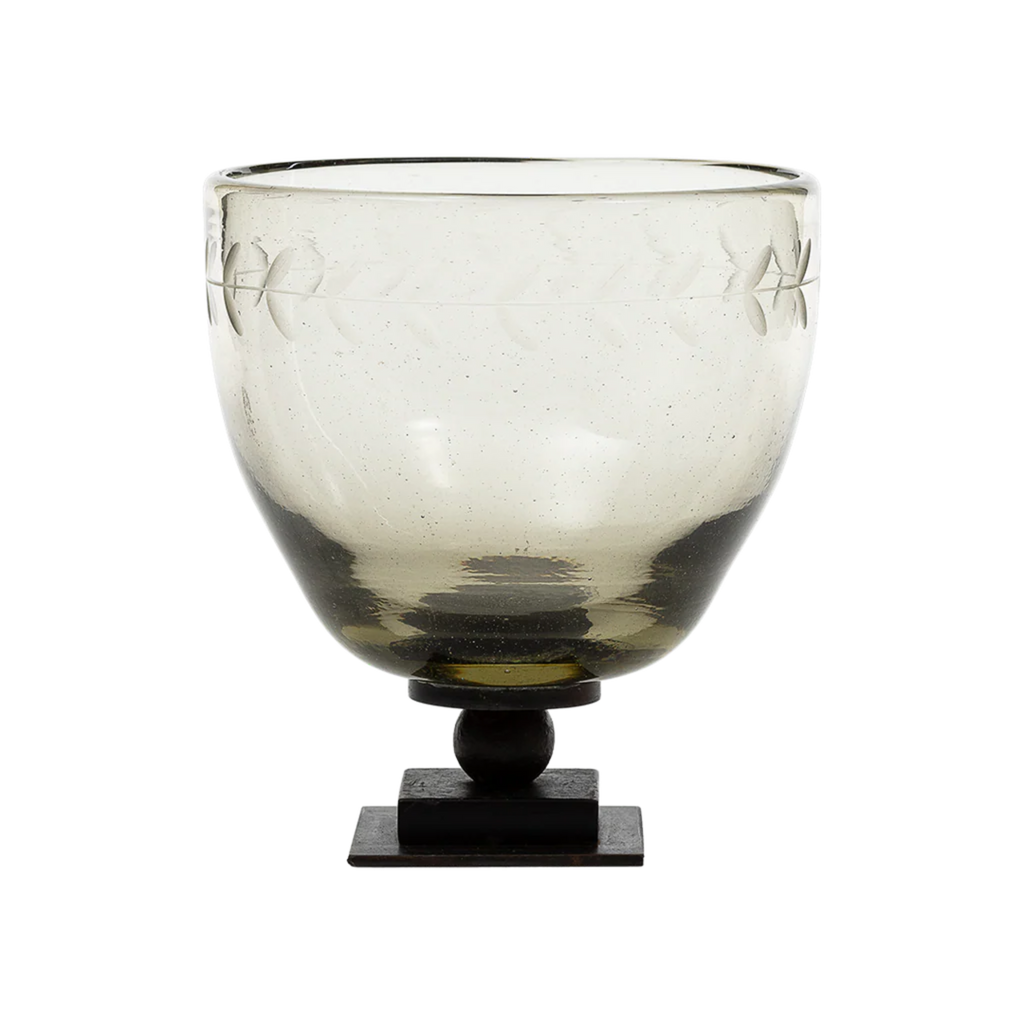 Decorative glass bowl with an iron base on a white background