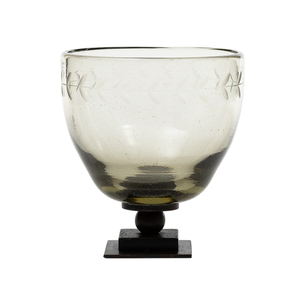 Decorative glass bowl with an iron base on a white background