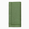 Clover green linen napking folded on white background.