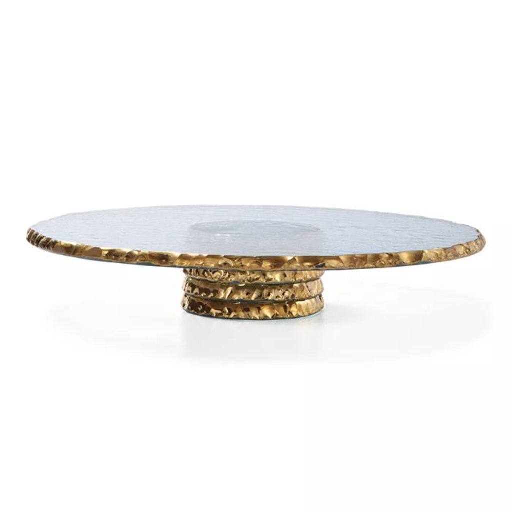 Round glasscake stand with gold  edges and gold base on a white background