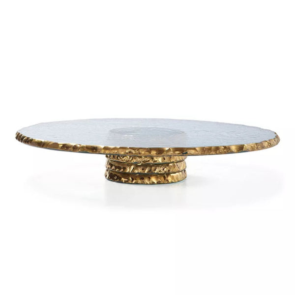 Round glasscake stand with gold  edges and gold base on a white background