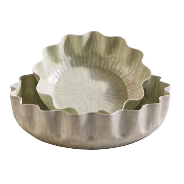 Two green enamel bowls with scalloped edges.