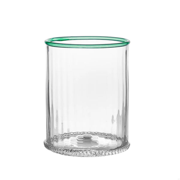 Clear glass tumbler with green rim on a white background