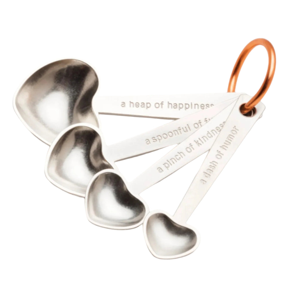 Heart shaped measuring spoons on white background.