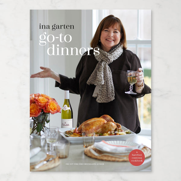 Book cover of 'Go-To Dinners' by Ina Garten with Ina at a dinner table.
