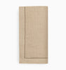 Natural linen napkin with a decorative hem on a white background