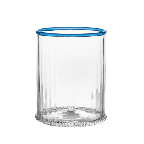 Clear rippled glass with blue rim on white background. 