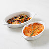 Juliska Puro Stoneware oval bakers with vegetables on marble counter top.