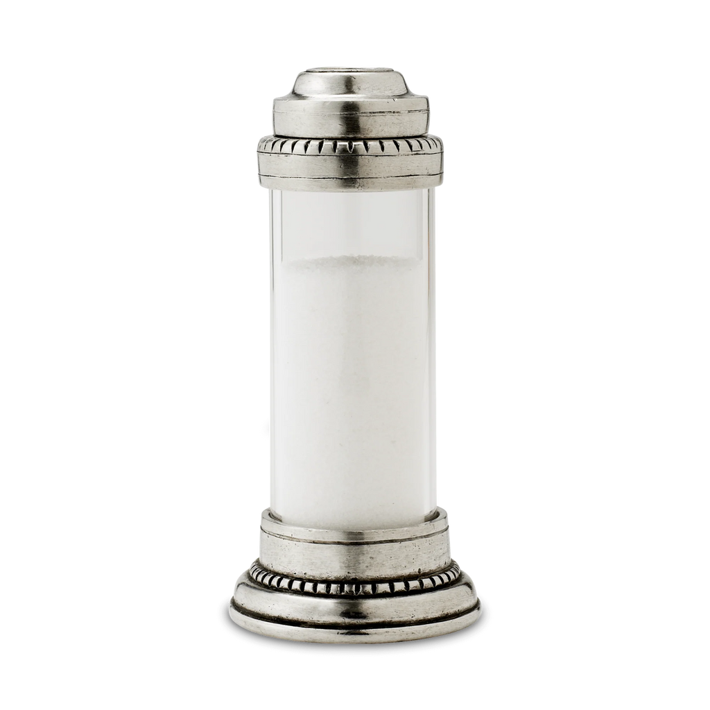 Pewter and glass salt shaker on white background.