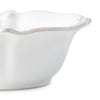 Detail of white scalloped berry and thread cereal bowl on white background. 