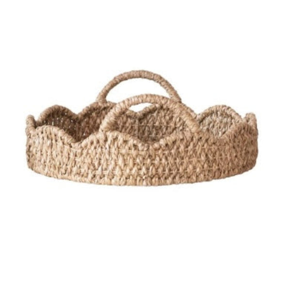Round rattan scalloped tray on white background.