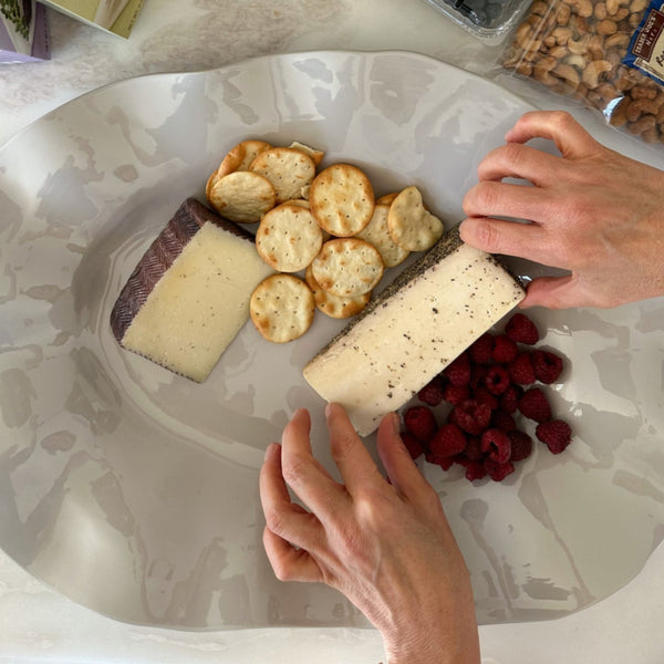 Stone wavy platter with cheese, crackers and berries 