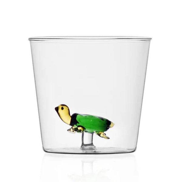 Clear glass with turtle inside on white background.