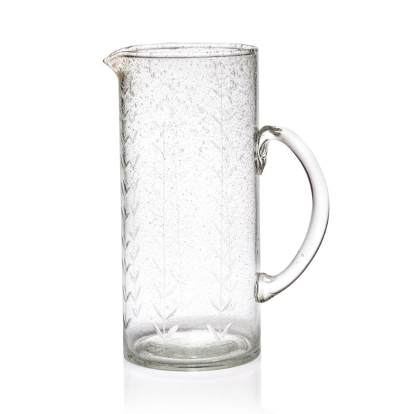 Hand etched glass pitcher on white background.
