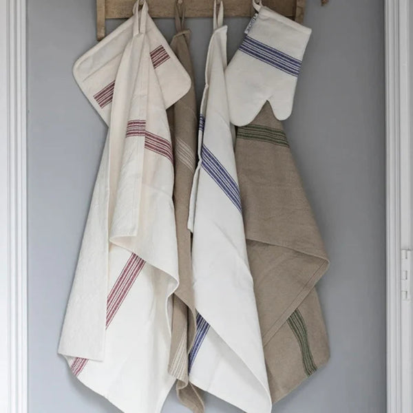 Set of vintage striped kitchen towels and an oven mitt hanging on a wooden rack against a gray wall.