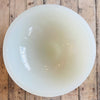 White resin bowl on a wooden surface