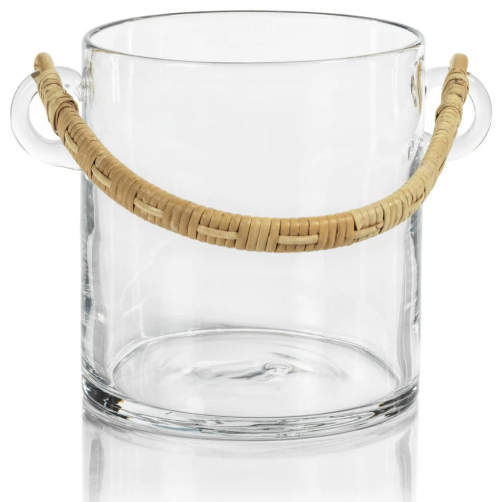 Clear glass ice bucket with rattan handle on white background.