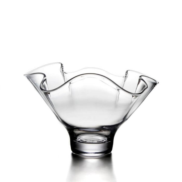 Large Simon Pearce Chelsea bowl made of clear hand-blown glass with a narrow base and a wide wavy rim.