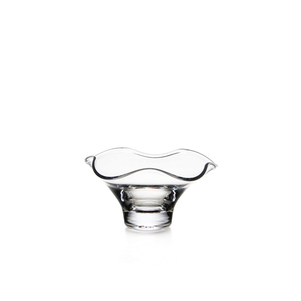 Small Simon Pearce Chelsea bowl made of clear hand-blown glass with a narrow base and a wide wavy rim.